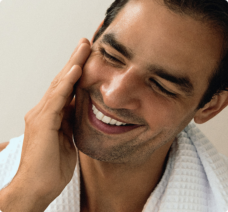 Man touching face with healthy skin